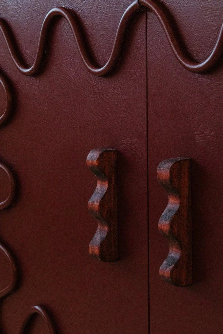 ATHAR decorative hooks on a burgundy panel